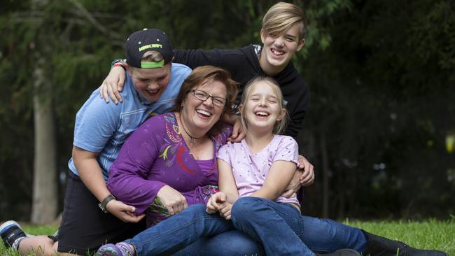 Deaf mum Karina Elliott, 49, with her kids Jared, 11, Jonah, 12, and Naomi, 9, has taken out NSW Mother of the Year. Picture: Justin Lloyd