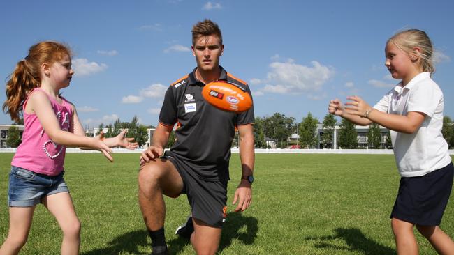 Giants player Adam Tomlinson watches the Auskick practice.