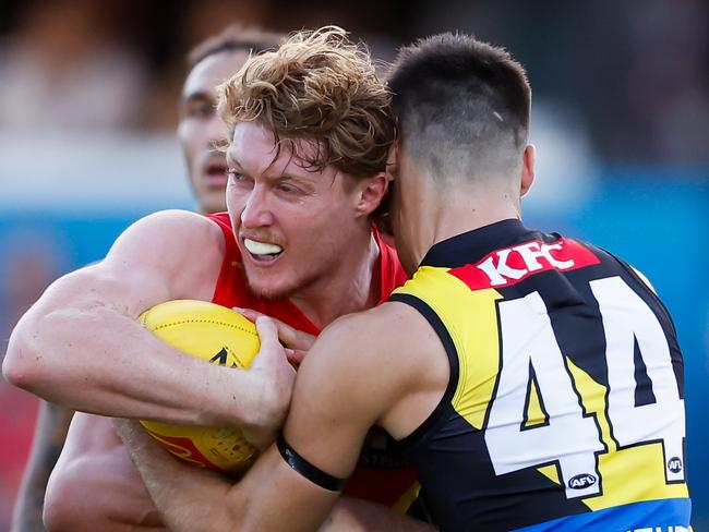 GOLD COAST, AUSTRALIA - MARCH 09: Matt Rowell of the Suns is tackled by Seth Campbell of the Tigers during the 2024 AFL Opening Round match between the Gold Coast SUNS and the Richmond Tigers at People First Stadium on March 09, 2024 in Gold Coast, Australia. (Photo by Dylan Burns/AFL Photos via Getty Images)