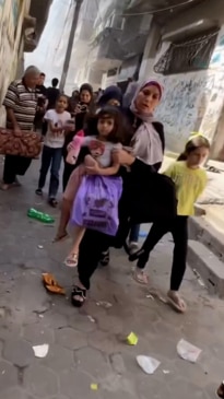 Terrified women and children flee Israeli explosions