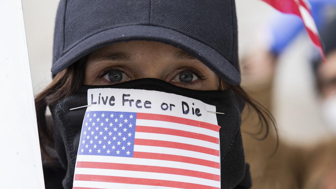 A protester is seen with a Live Free or Die mask outside of the New York State Capitol.