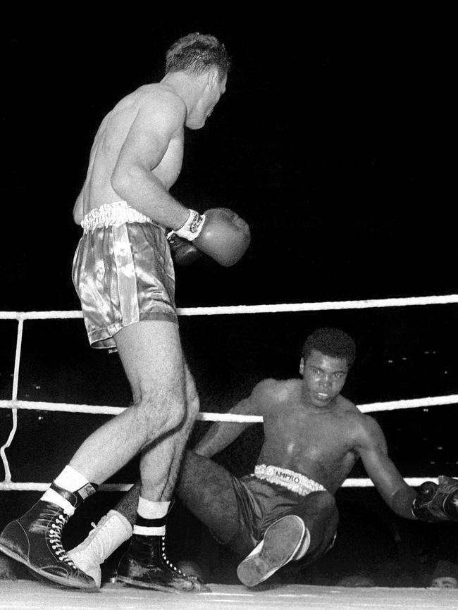 Ali being knocked down by Henry Cooper during their heavyweight bout at Wembley Stadium in London in 1963.