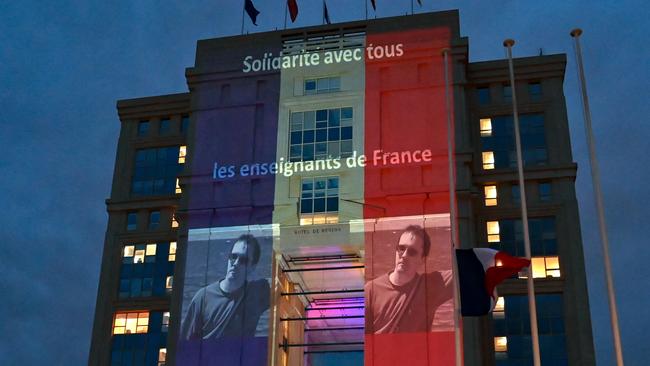 A portrait of French teacher Samuel Paty is projected onto the facade of the Hotel de Region in Montpellier this week. Picture: AFP