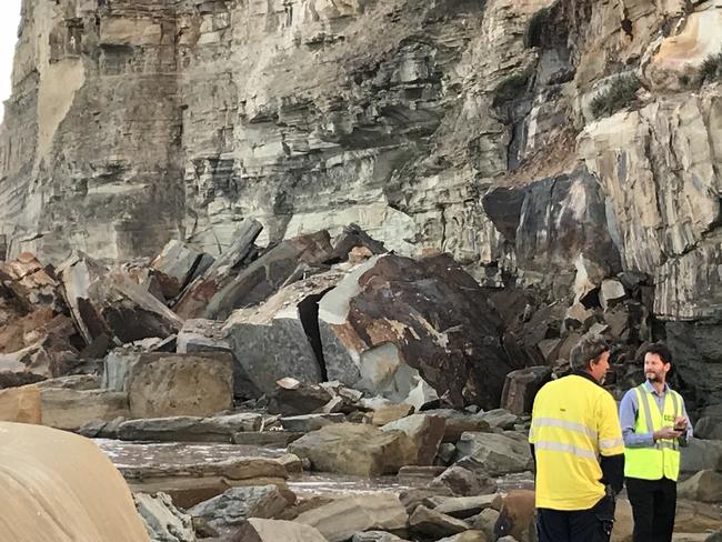 Council stand near a huge pile of fallen rock. Picture: Cathy Stubbs.