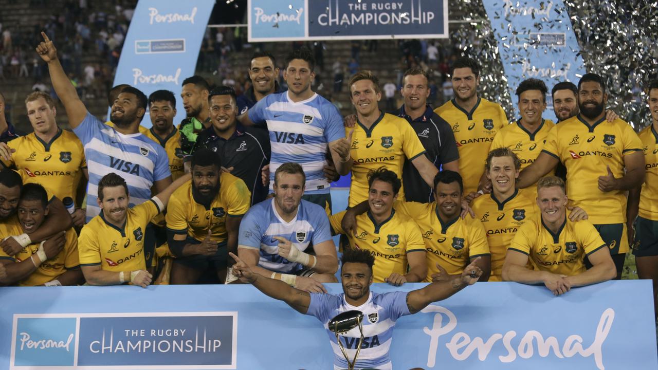 Wallabies players celebrate with the trophy at Estadio Padre Ernesto Martearena.