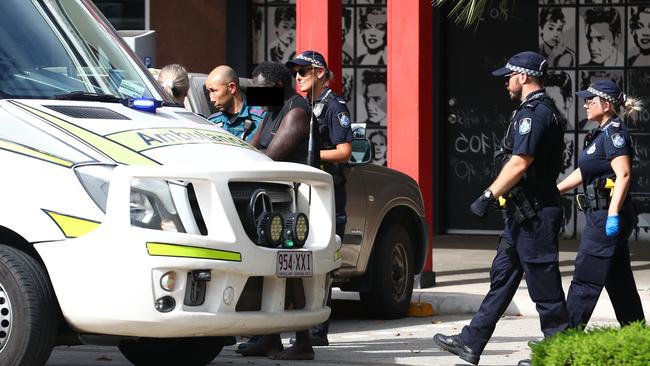 Police officers assist paramedics with a heavily intoxicated man in the Shields Street Mall. The man was taken to the Lyons St Diversionary Centre. Picture: Brendan Radke