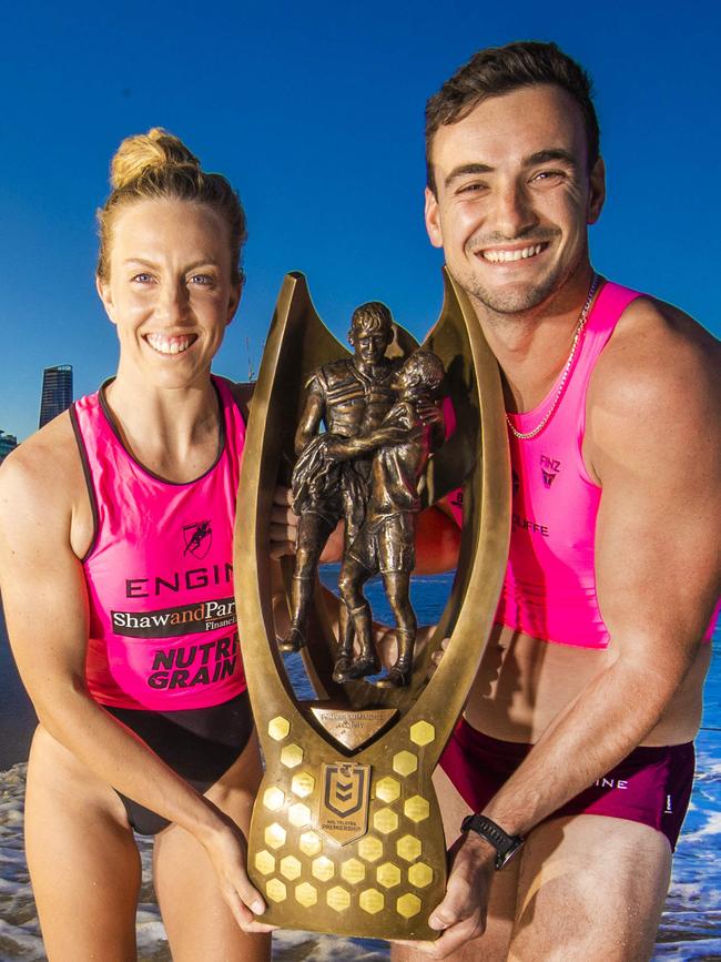 Riley Fitzsimmons and Georgia Miller with the NRL premiership trophy.