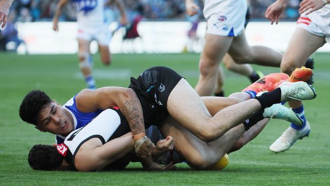 Josh Sinn of the Power is tackled by Paul Curtis of the Kangaroos. Photo by James Elsby/AFL Photos.