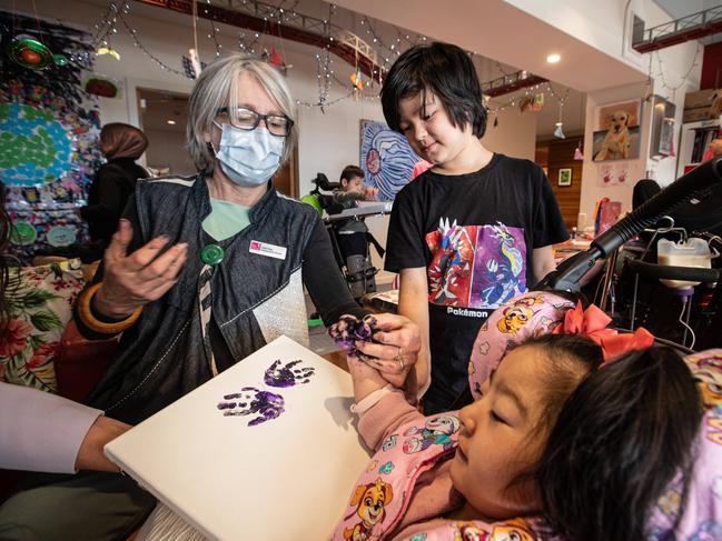 Registered art therapist Judy King with Jessica and Liam, creating memories for the family. Picture: Julian Andrews