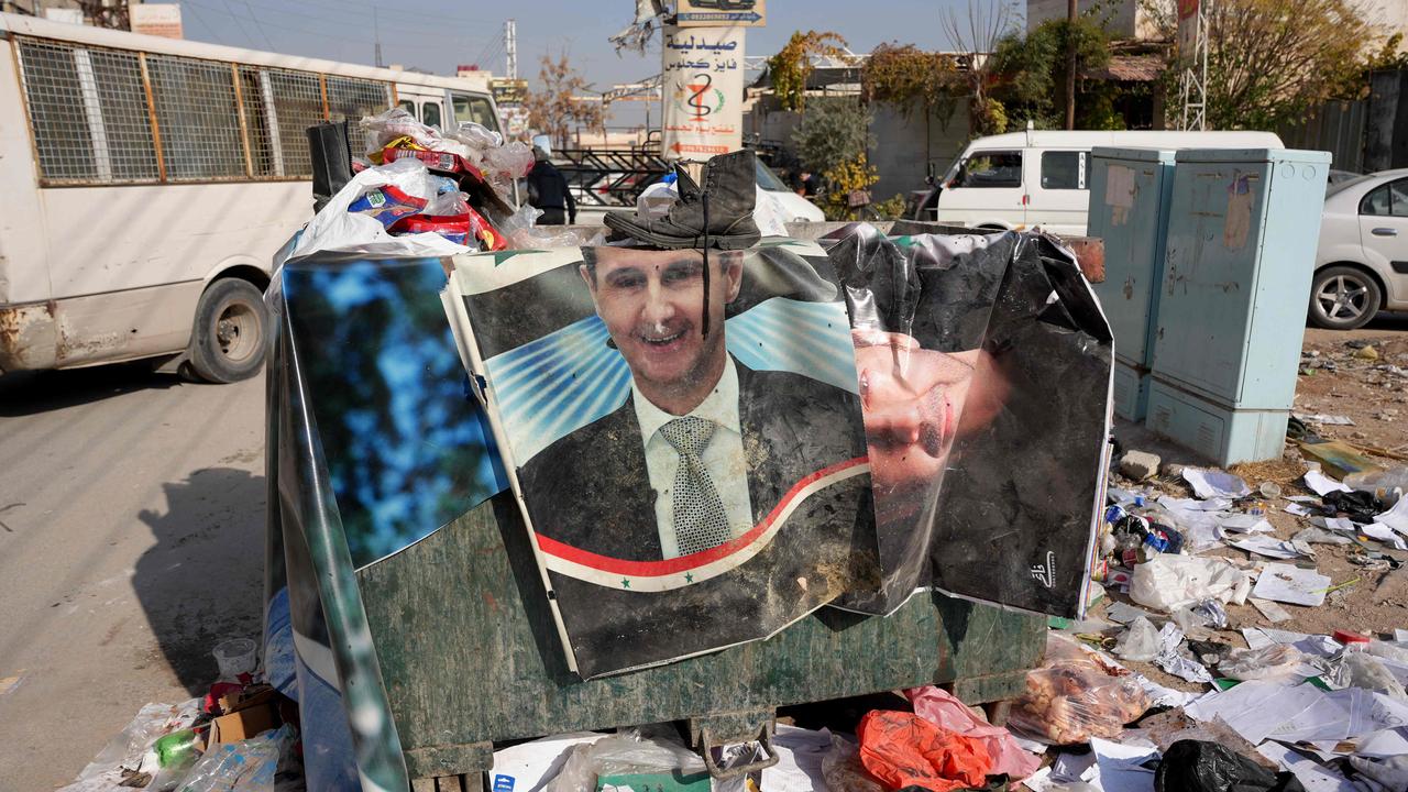 Portraits of ousted Syrian ruler Bashar al-Assad are dumped in a skip in the Damascus suburb of Daraya on December 9. Islamist-led rebels took Damascus in a lightning offensive on December 8, sending President Bashar al-Assad fleeing and ending five decades of Baath rule in Syria. Picture: Rami al Sayed / AFP