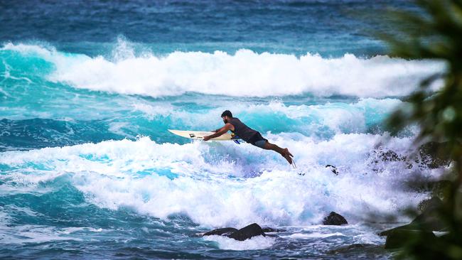 Surfers enjoy a morning surf at Burleigh Heads. Picture: NIGEL HALLETT