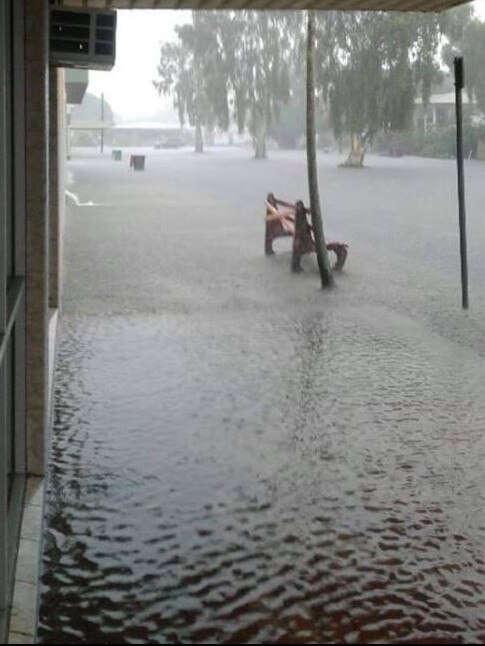 Flooding outside the Home Hill Newsagency.