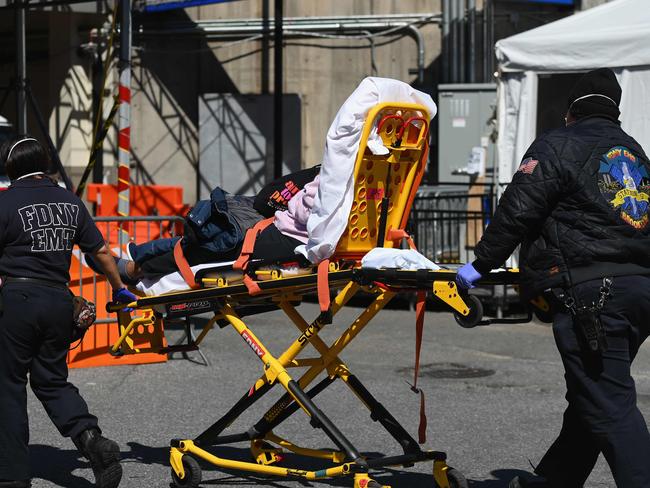 Paramedics roll a stretcher with a patient to Brooklyn Hospital Center emergency room on March 27, 2020 in New York City. Picture: AFP