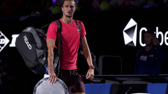 Germany's Alexander Zverev walks off the court with the runner-up trophy. (Photo by Martin KEEP / AFP)