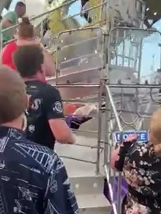 People look on in horror after a 25-year-old woman fell about 30m from the Hang Over ride at the Cairns Showfest.