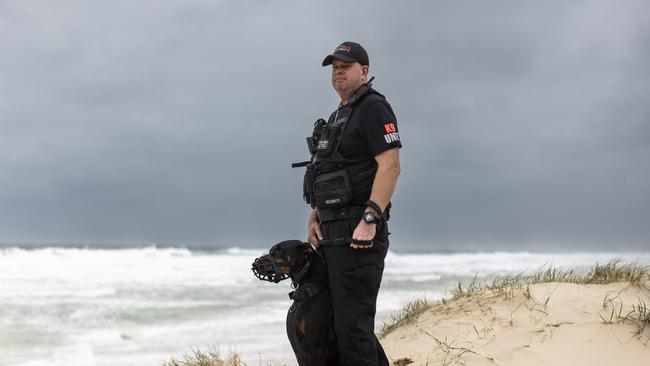 On the beat: Wayne Heneker and his patrol dog at Surfers Paradise. Picture: David Kelly