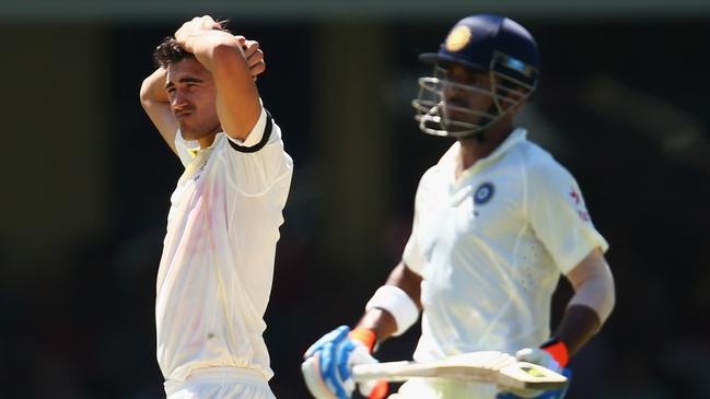 SYDNEY, AUSTRALIA - JANUARY 08: Mitchell Starc of Australia looks frustrated after a dropped catch by captain Steve Smith during day three of the Fourth Test match between Australia and India at Sydney Cricket Ground on January 8, 2015 in Sydney, Australia. (Photo by Cameron Spencer/Getty Images)