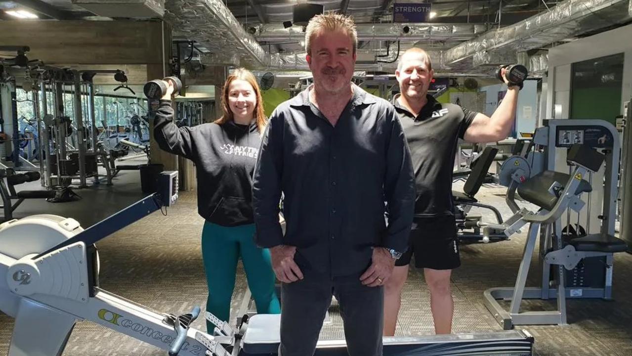 Townsville Anytime Fitness staff members Kelly McKerrow and Darren Mitchell with franchisee Troy Cooper in front. Picture: Tony Raggatt