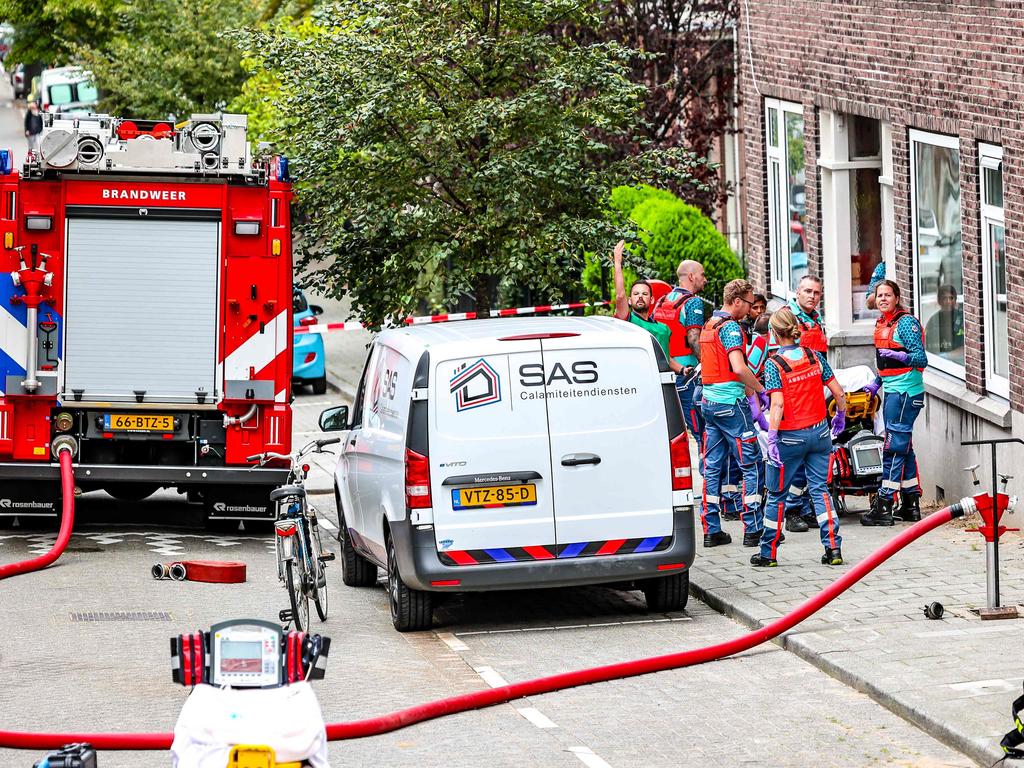 Members of the fire brigade work at a fire in a building on Heiman Dullaertplein, after shootings in Rotterdam. (Photo by Marco van der Caaij / ANP / AFP) / Netherlands OUT