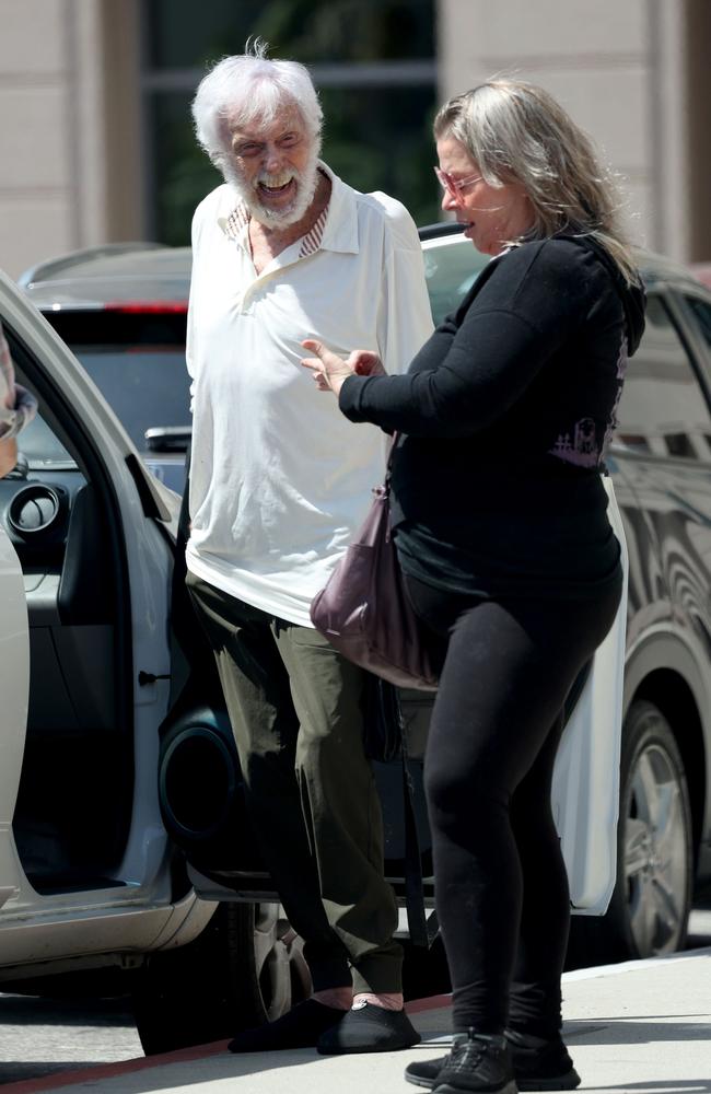 As the star got in the car, his wife gave their friend a big hug before heading home. Picture: Splashnews.