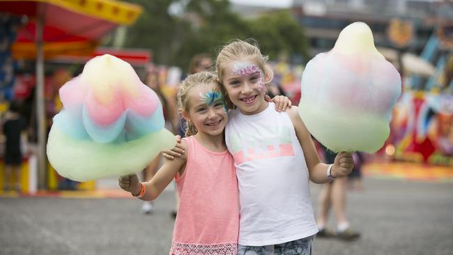 Sisters Sophie, 6, and Taylor Journeaux, 8, with fairy floss flowers. Picture: Dylan Robinson