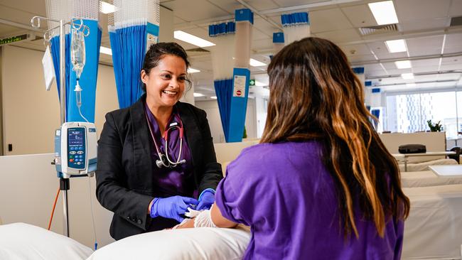 CMAX principal investigator Dr Angela Molga with a study participant in their clinical research facility on North Tce.