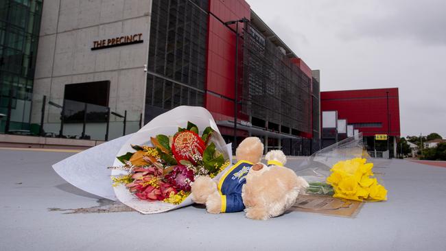 Flowers lay on top of the Paul Green plaque at Suncorp Stadium in Brisbane. Picture: Jerad Williams