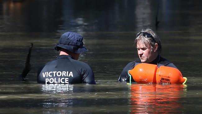 Victorian police divers search the Murray River for a missing boy on Friday, March 3, 2017, in Moama, New South Wales, Australia. The child’s body was found in the river the following morning. Picture: Hamish Blair