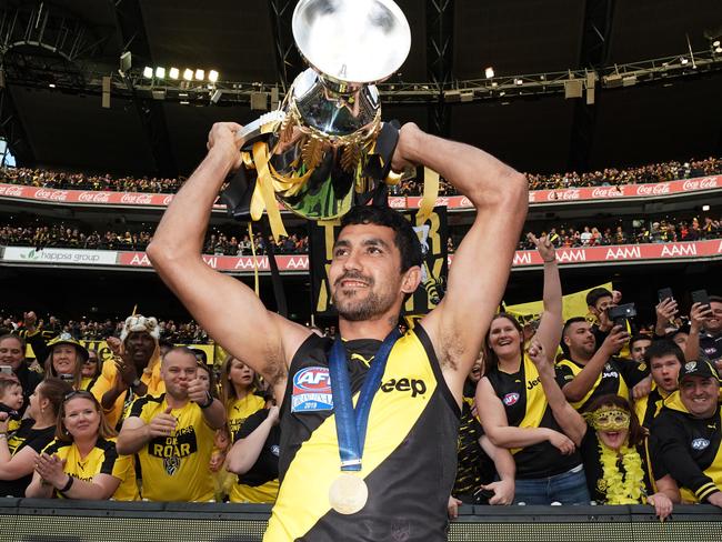 Marlion Pickett of the Tigers celebrates the win with the Premiership Cup during the 2019 AFL Grand Final between the Richmond Tigers and the GWS Giants at the MCG in Melbourne, Saturday, September 28, 2019. (AAP Image/Michael Dodge) NO ARCHIVING