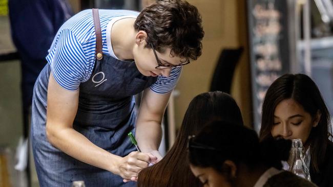 MELBOURNE , AUSTRALIA - NewsWire Photos DECEMBER 08 , 2020  ; Major industrial relations reforms will be debated in Federal Parliament today in regards to workers conditions. A waiter takes an order in Degraves St. CBD. Picture : NCA NewsWire / Ian Currie