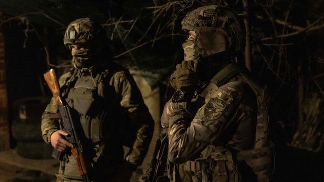 Ukrainian soldiers from the 5th Assault Brigade gather before heading for a 4-day rotation to the frontline, in an undisclosed area near the town of Chasiv Yar, Donetsk region, on March 28, 2024, amid the Russian invasion of Ukraine. The eastern city of Chasiv Yar is facing a "difficult and tense" situation, a Ukrainian army official said on March 25, 2024. If Russia took Chasiv Yar, it could step up attacks on the strategic city of Kramatorsk that is already facing growing bombardment. (Photo by Roman PILIPEY / AFP)