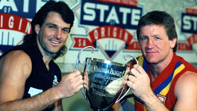 Victorian captain Paul Roos and South Australian skipper Chris McDermott hold the Malcolm Blight Cup ahead of the 1992 State of Origin game.