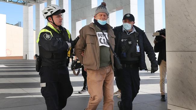 A member of Extinction Rebellion was handcuffed and led away by police. Picture: NCA NewsWire / Gary Ramage