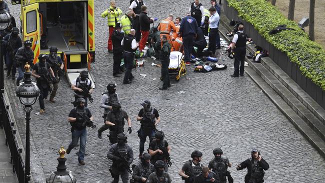 Armed police descend on London’s Houses of Parliament where an unarmed colleague was one of five people killed and 40 injured in a suspected terrorist attack. Picture: Stefan Rousseau/PA via AP.