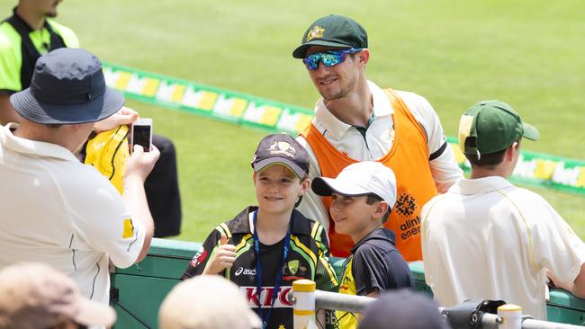 Cameron Bancroft poses for a selfie with fans on Day 1 of the test match between Australia and Pakistan at the Gabba. Photo Lachie Millard