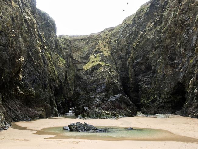 ONE TIME WEB USE ONLY - FEE APPLIES FOR REUSE -  The Crantock rock carving on Crantock Beach, Devon that reveal a beautiful secret at low tide.See SWNS story SWCAVE; Images reveal a hidden poem carved inside a Cornish cave which is only accessible at low tide. Crantock might only be a stone's throw from Newquay, Cornwall's liveliest resort, but its location between the two Pentire headlands ensures it remains a place of peace and tranquility. On the far side of the beach, an intriguing series of small caves hidden in the cliff walls hold a secret few could ever spot without knowing what to look for. Only at low tide can you see the mythical Crantock rock carving, which is the stuff of legend in the local area.  Picture: SWNS/Mega