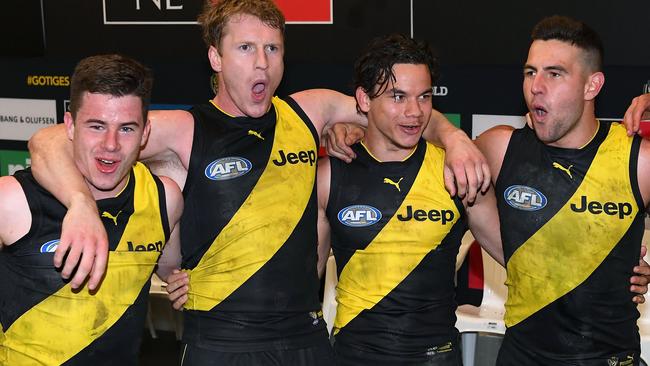 Jack Higgins, Josh Caddy, Daniel Rioli and Jack Graham sing the song after beating the Cats. Pic: Getty Images