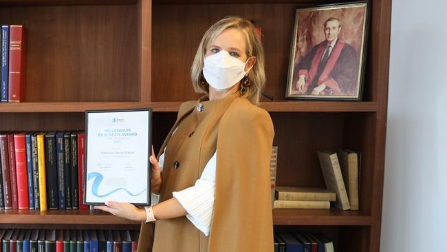 Diabetes Australia Group chief executive Justine Cain holding the Diabetes Australia Millennium Award.