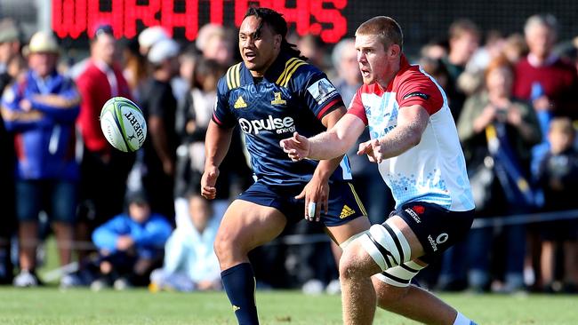 Tom Staniforth of the Waratahs passes the ball during the Super Rugby pre-season match between the Highlanders and the Waratahs.