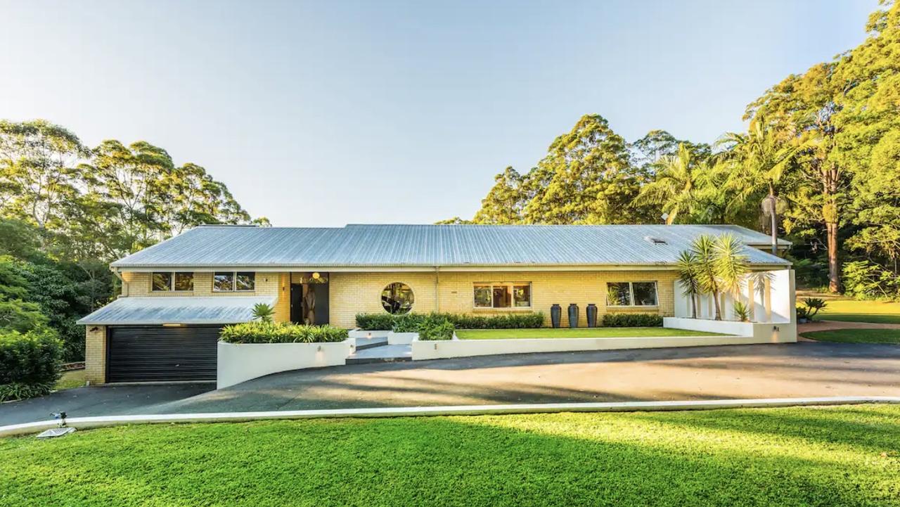 The perfectly manicured lawns with the tree-lined driveway makes this Coffs Harbour Airbnb a "home among the gum trees".