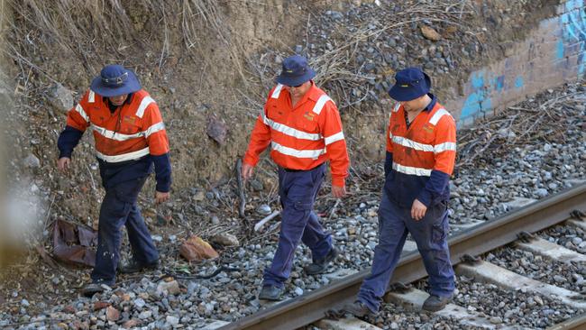 ARTC workers walk a rail line. Photo: (AAP Image/Russell Millard)