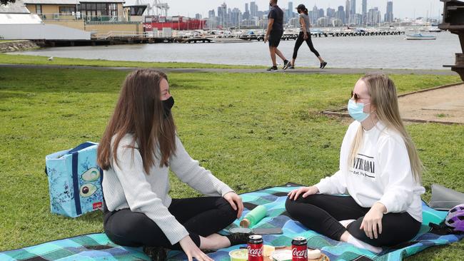 Yayla Grant and Jessica McEwan enjoy a picnic in Williamstown after restrictions were lifted sightly. Picture: NCA NewsWire/David Crosling