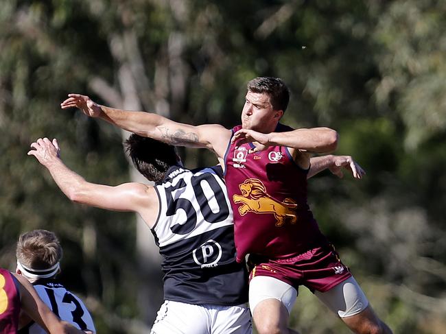 Palm Beach-Currumbin's Tyson Dyer and Western Magpies' Alex Dickfos in action at the QAFL qualifying final between Palm Beach-Currumbin and Western Magpies on Saturday. Photo: Jerad Williams