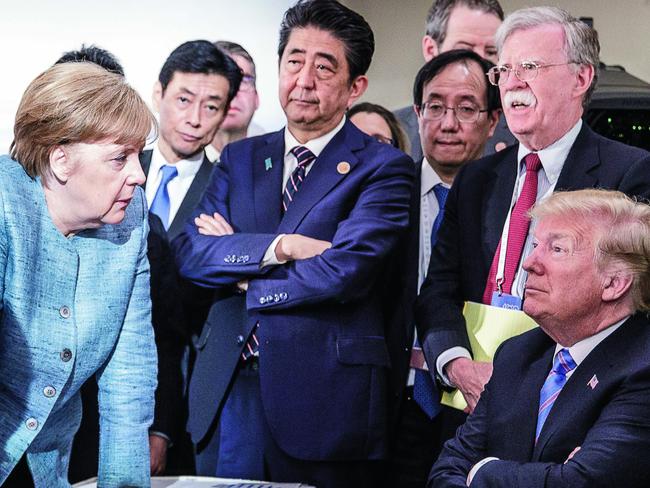 Mr Trump, with Mr Bolton standing to his right, with German Chancellor Angela Merkel. Picture: Getty