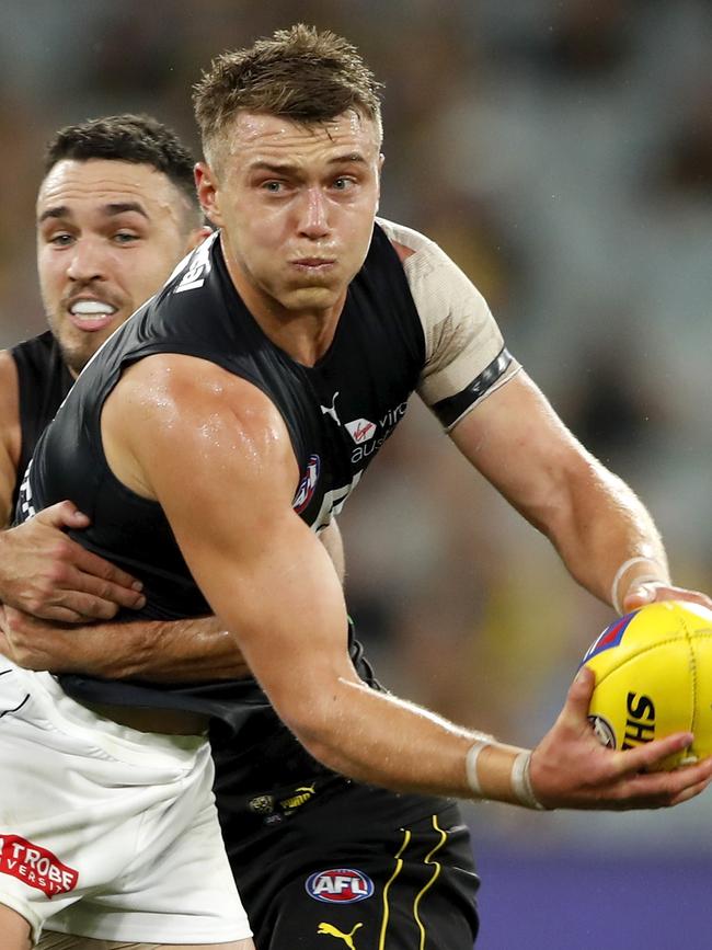 Patrick Cripps finds himself in a tackle by Shane Edwards.