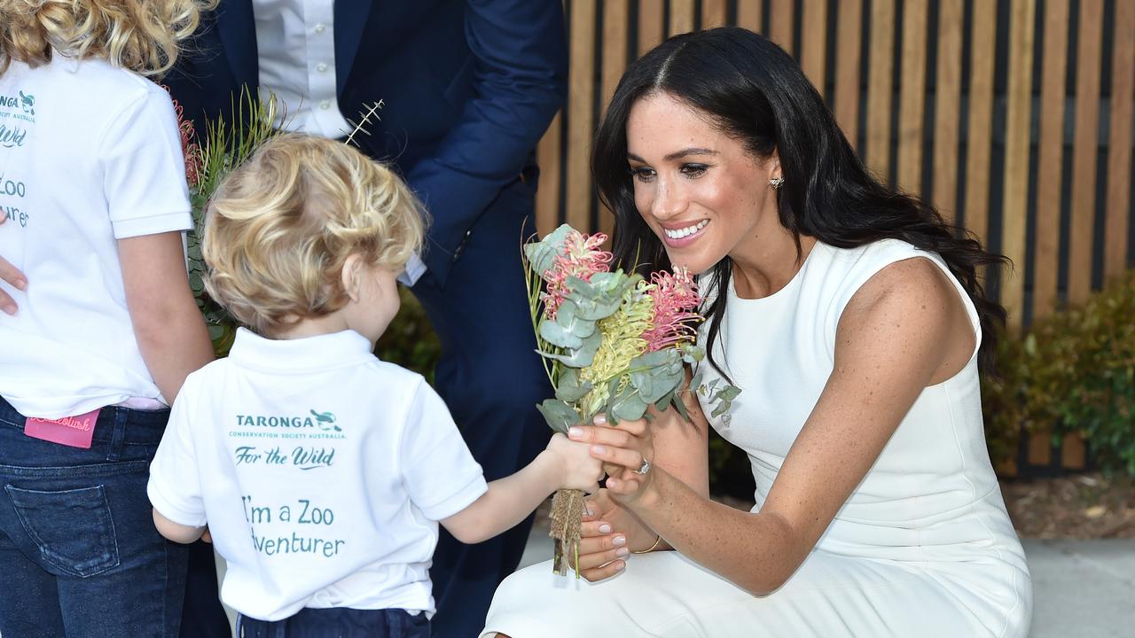 Meghan receives native flowers from 4-year-old Findlay Blue after she and Prince Harry, the Duke of Sussex, officially opened the Taronga Institute of Science and Learning during a visit to Taronga Zoo Picture: Peter Parks/AAP Image/AFP Pool.