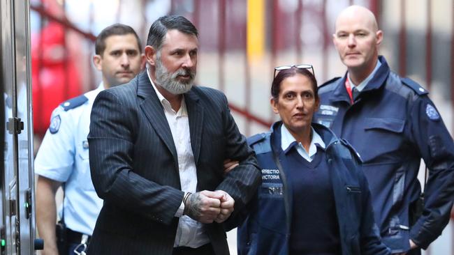 Karl Michael Hague is escorted from a prison van to be sentenced in the Supreme Court of Victoria in Melbourne, Friday, June 15, 2018. Picture: AAP/David Crosling.