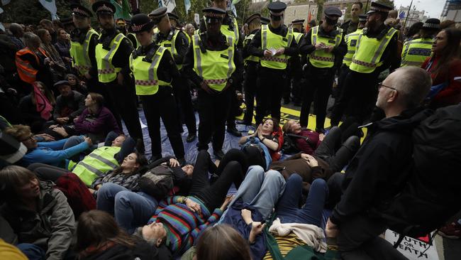 LONDON: Extinction Rebellion climate change protesters lie down and block the street on Millbank in London. Picture: AP Photo/Matt Dunham