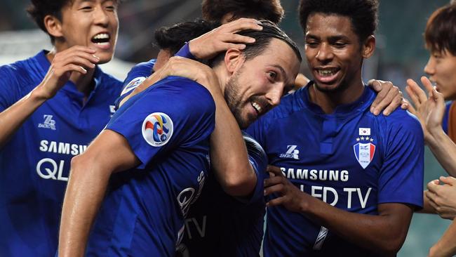 Suwon players celebrate after Dejan Damjanovic (centre) scored against Sydney FC.