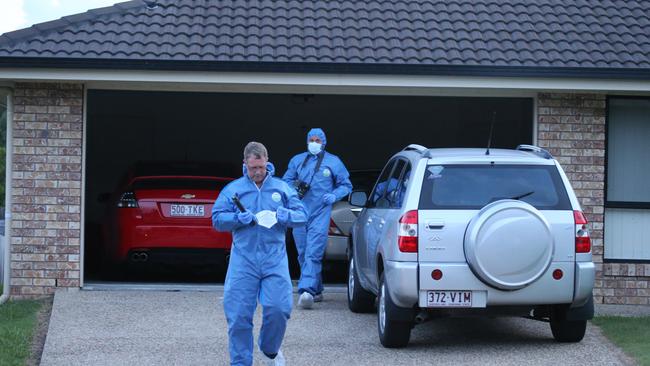 Police comb the area in front of the Upper Coomera house where two bodies were found. Picture Glenn Hampson